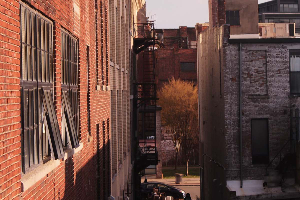 The brick front of 2711 Larimer Street at dusk.